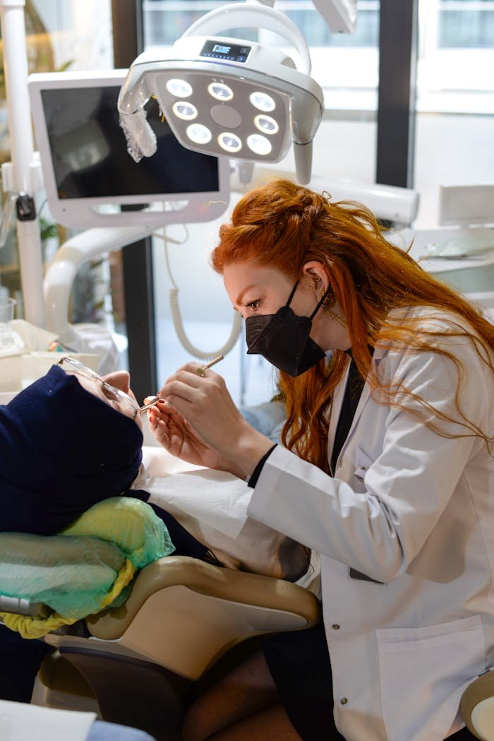 contact-img Professional female dentist working on a patient's teeth in a modern dental clinic.